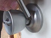 Depress button to get handle on