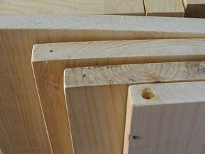 Drill holes in corner of shelves for dowel pin hinge