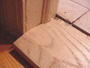 Slide in threshold beneath molding