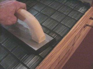 Spread grout with rubber float